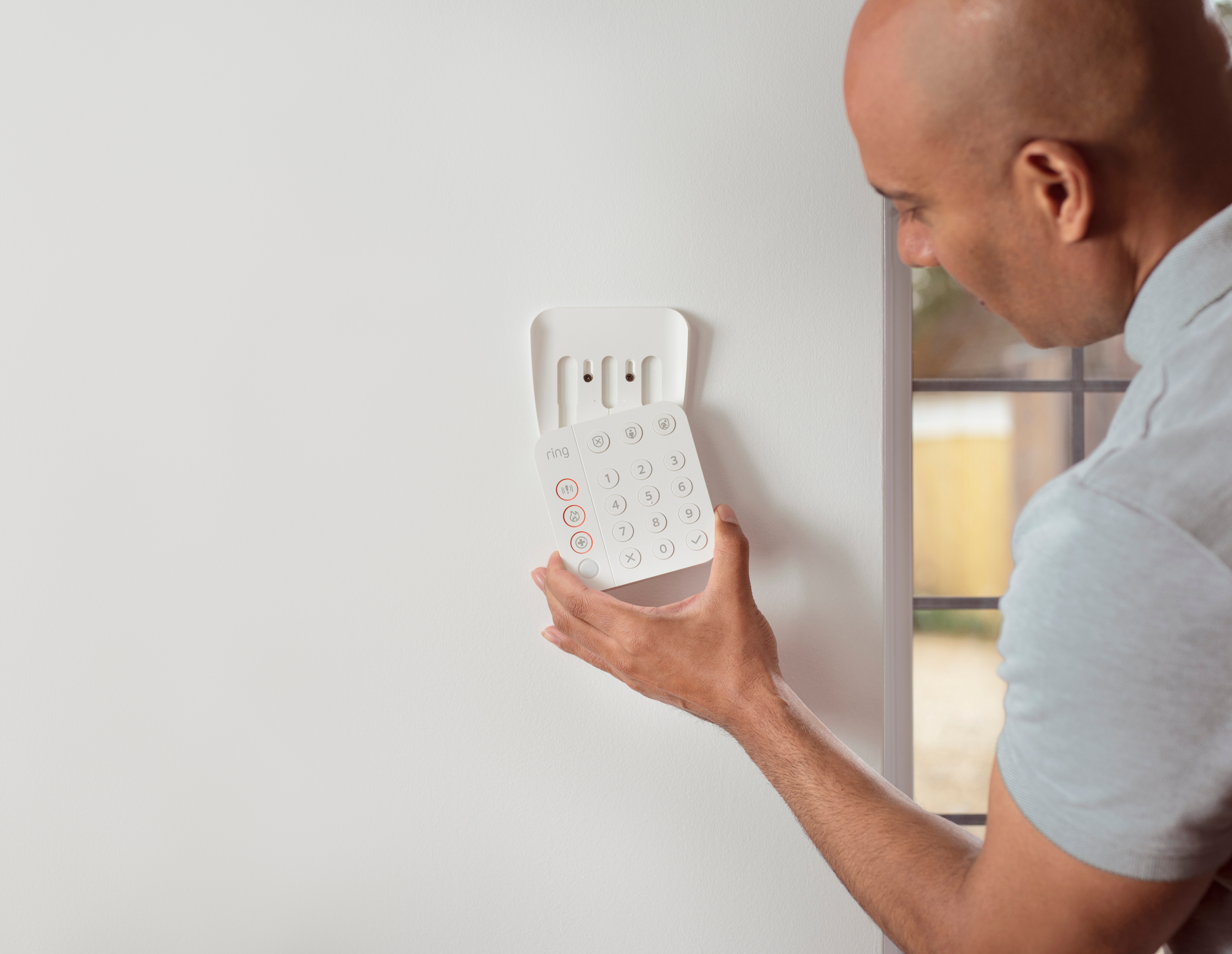 man adjusting an alarm