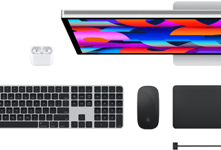 Top view of Mac accessories: Studio Display, AirPods, Magic Keyboard, Magic Mouse and Magic Trackpad