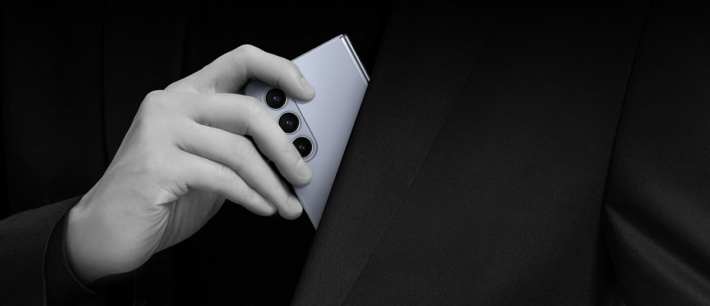 a person place his phone inside his jacket pocket