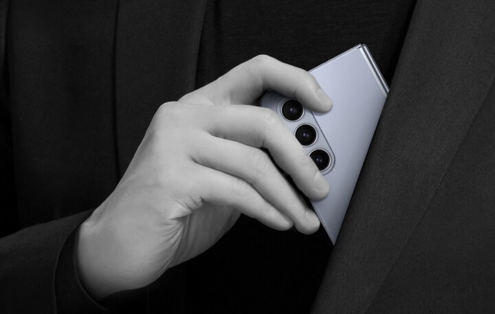 a person place his phone inside his jacket pocket