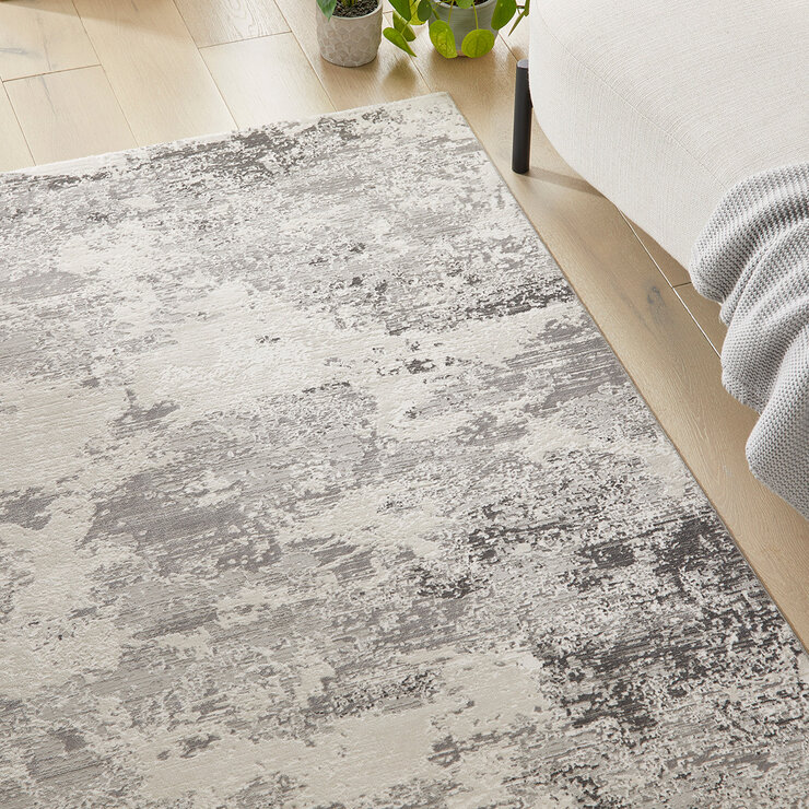 Close-up of a grey and brown rug with a marbled texture