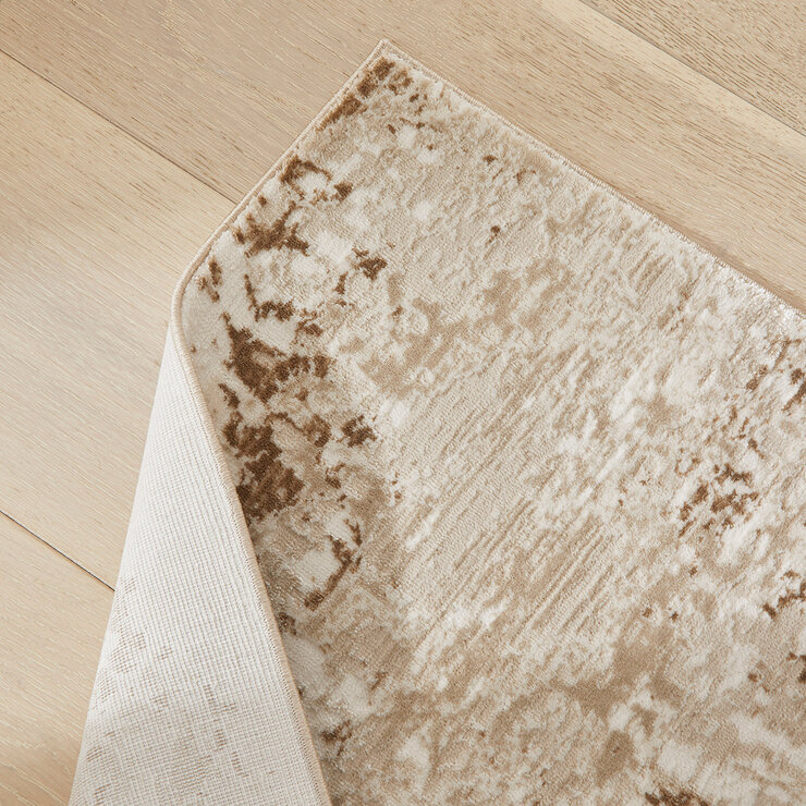 Close-up of a beige and brown rug with a marbled texture