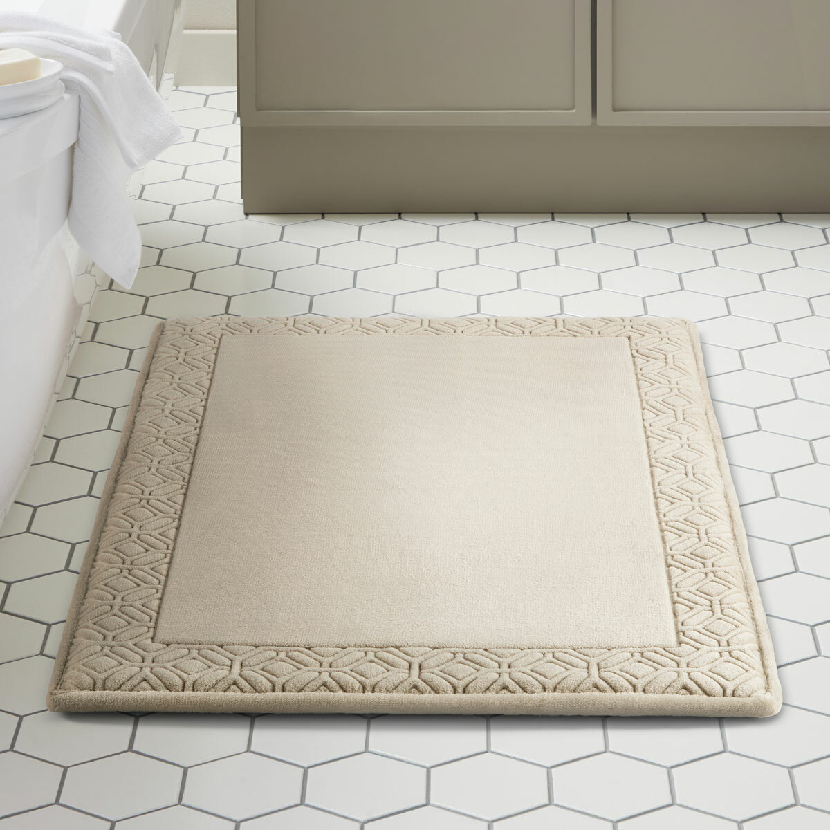 Taupe bath mat styled in a modern bathroom