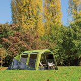 Lifestyle showing the tent in a field surrounded by trees Lifestyle showing the tent in a field surrounded by trees