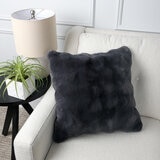 Grey square cushion on a beige sofa, with a bubble texture Grey square cushion on a beige sofa, with a bubble texture