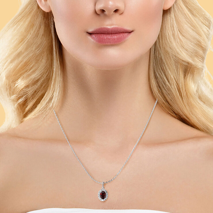 Oval Cut Ruby & 0.16ctw Diamond Halo Pendant, 14ct White Gold
