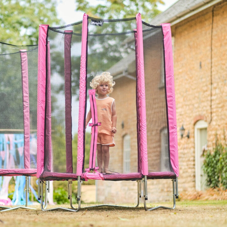 Lifestyle image of a child standing on the trampoline