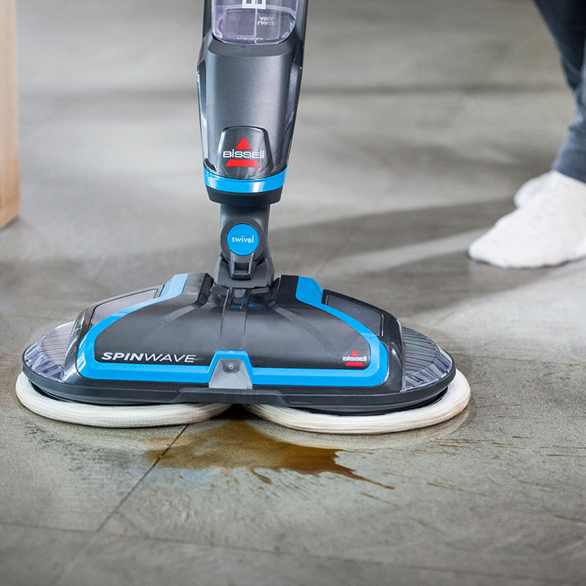 Lifestyle image of Bissell Spinwave cleaning up coffee stain