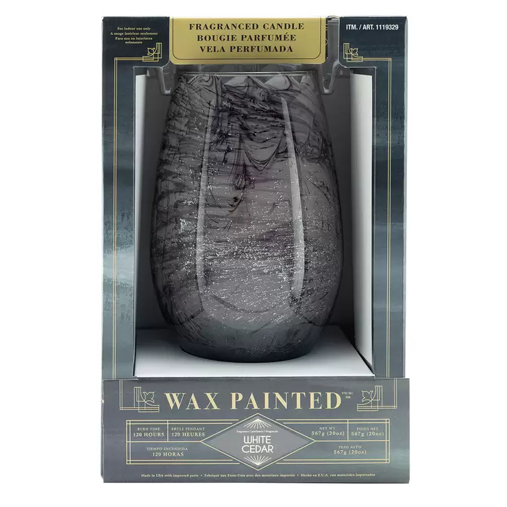 Lifetsyle image of grey candle in packaging face on Lifetsyle image of grey candle in packaging face on