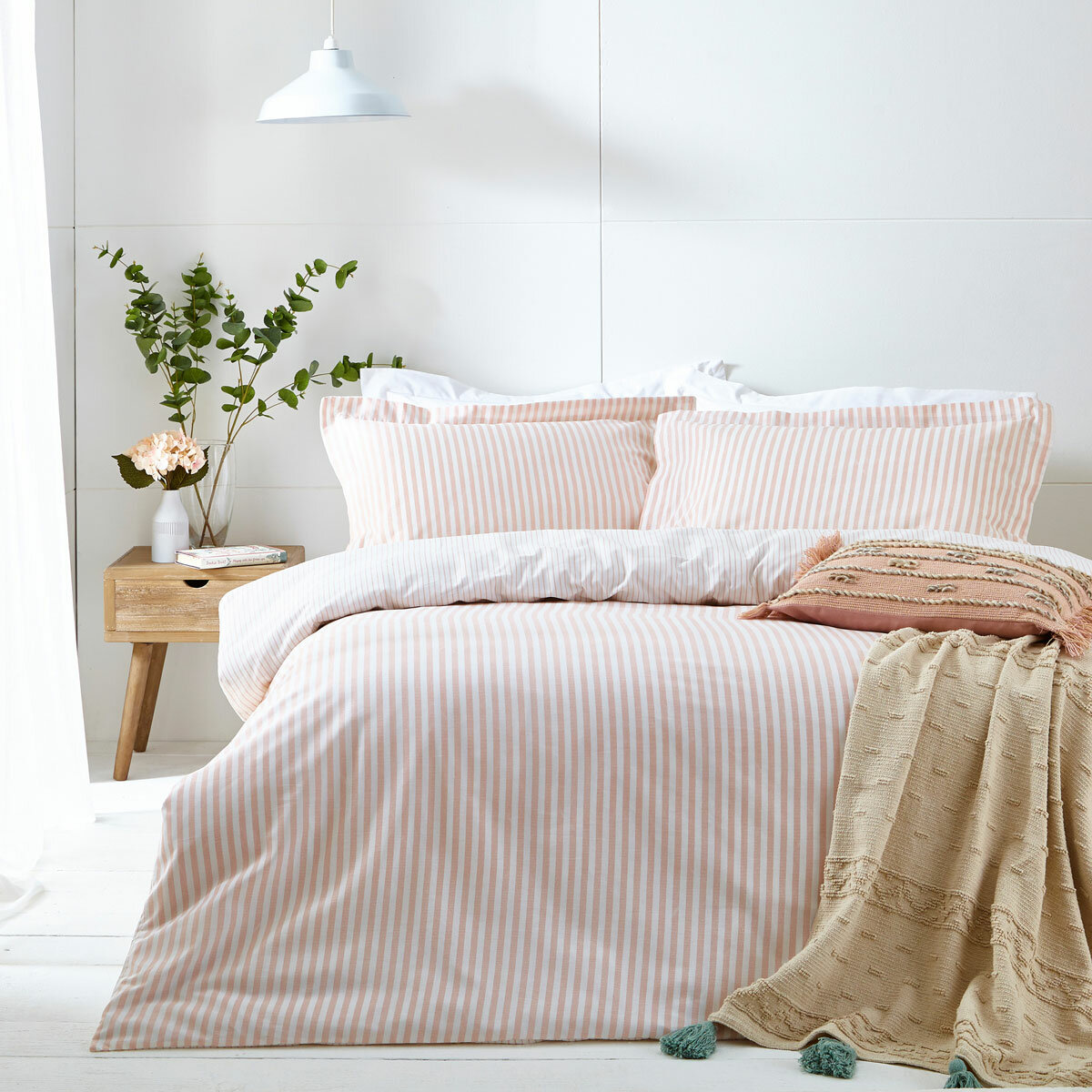 Pink and white vertically striped duvet set with matching pillowcases.