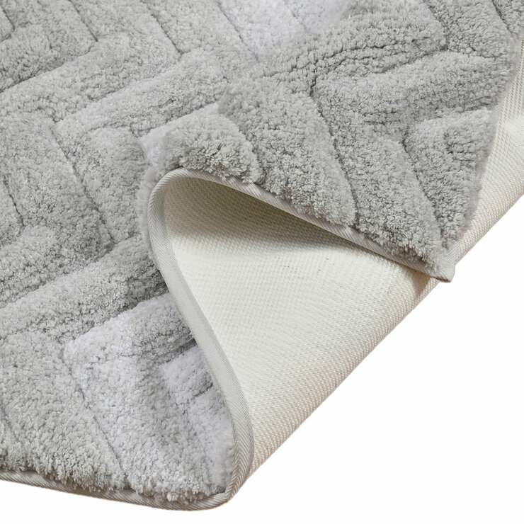 Textured bath mat folded with non skid backing