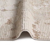 Neutral abstract rug with stone-like pattern in beige, taupe and off-white.
