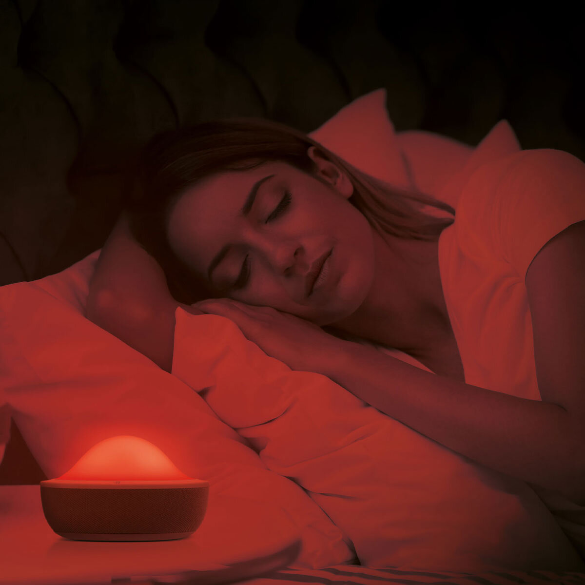 Lifestyle image of Aloha alarm clock glowing Red when person asleep