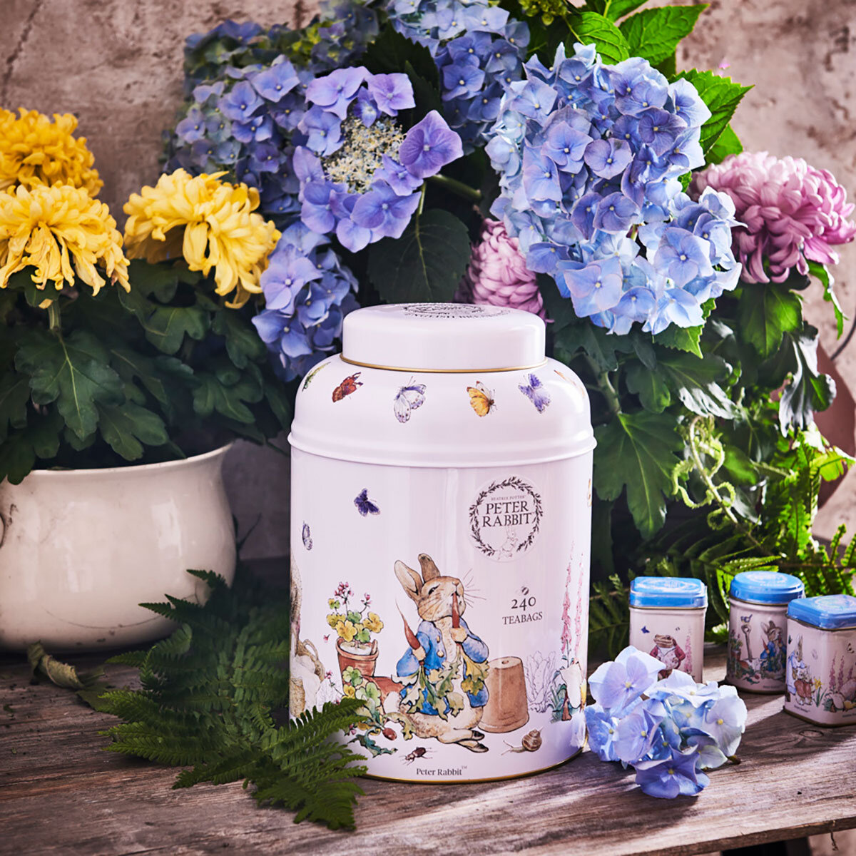 Lifestyle image of tea caddy surrounded by flowers