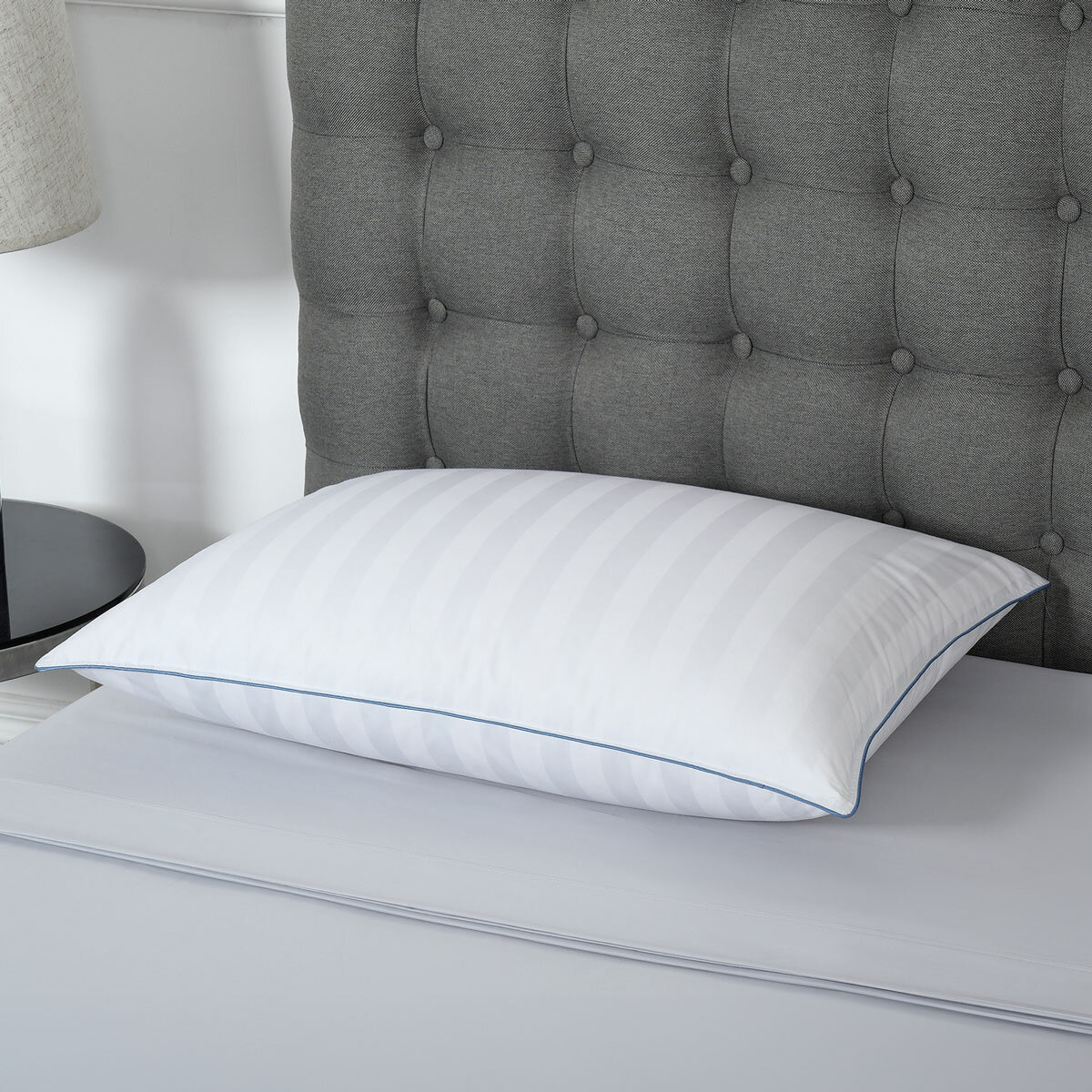 Duck fill breathable standard size pillow styled on bed. Duck fill breathable standard size pillow styled on bed.