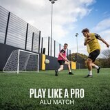 Lifestyle image showing two people playing football using the goal Lifestyle image showing two people playing football using the goal