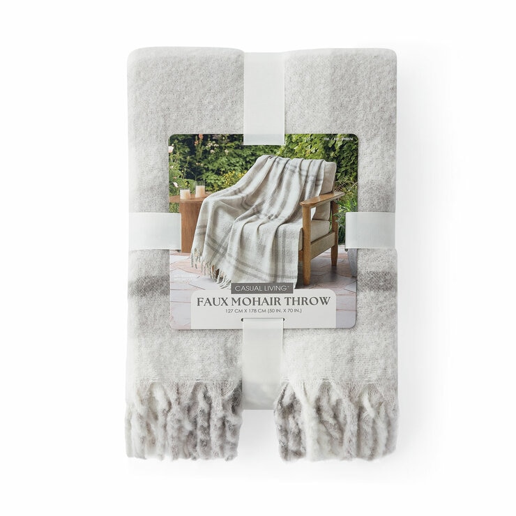Folded Grey  Mohair Faux Fur throw, with outer packaging shown