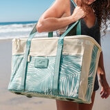 Lifestyle image of a woman carrying the Teal Clevermade Beach Tote Lifestyle image of a woman carrying the Teal Clevermade Beach Tote