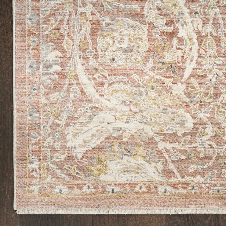 Pink and beige patterned rug with vintage-style floral and geometric motifs