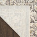 Beige and grey rug with central medallion and ornate symmetrical pattern Beige and grey rug with central medallion and ornate symmetrical pattern