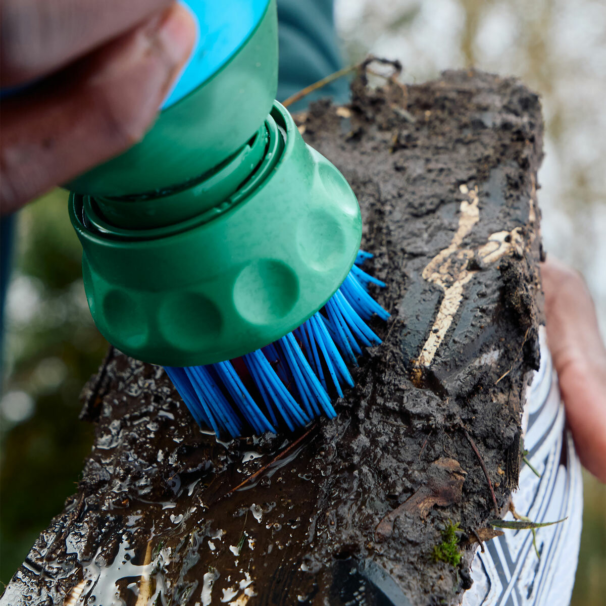 Lifestyle image of someone scrubbing their shoe