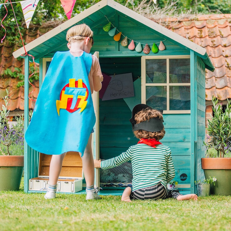 Lifestyle image of two children playing on the playhouse decking