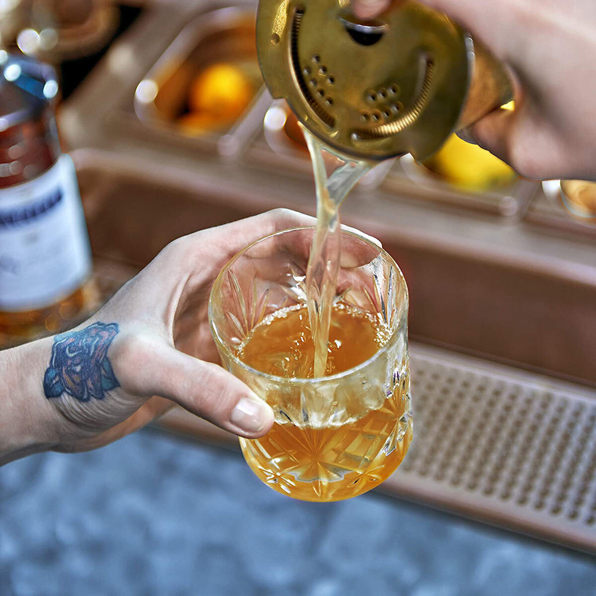 Lifestyle image of cocktail being poured