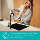 Lifestyle image of Bora Smart Dehumidifier 30L 's water tank being emptied