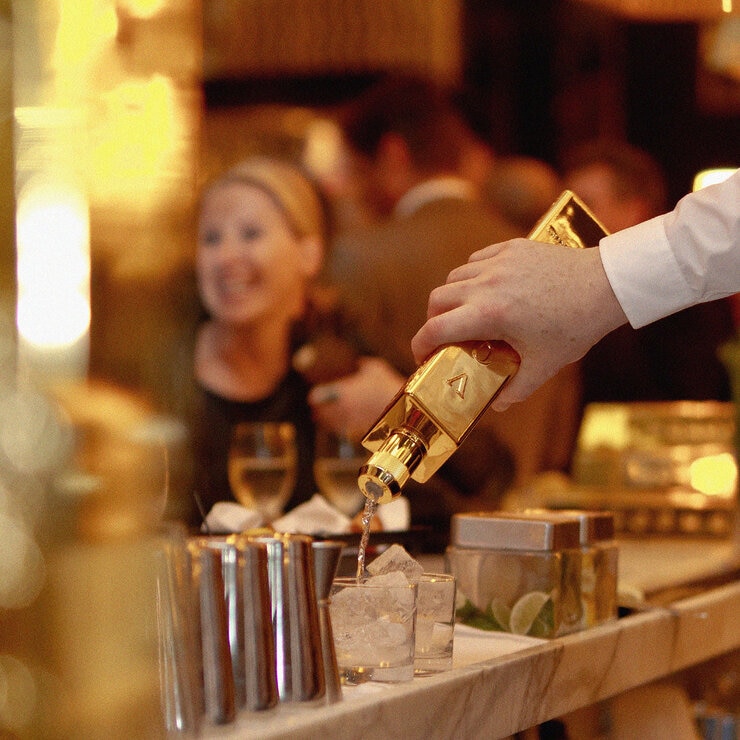3 kilos vodka being poured into glass at bar