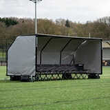 Lifestyle image of the Quickplay Pro Alu Club Shelter 16 x 6ft with chairs underneath (not included)