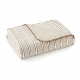 Taupe plaid throw, folded completely with a plain white background