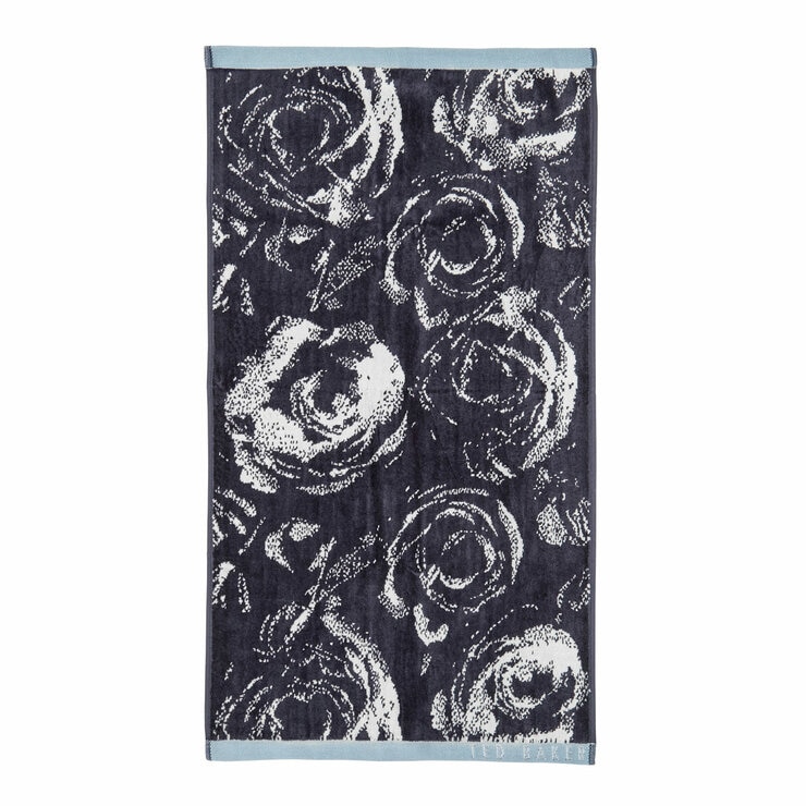Dark blue towel with white rose pattern, light pink borders, and “TED BAKER” branding in the corner