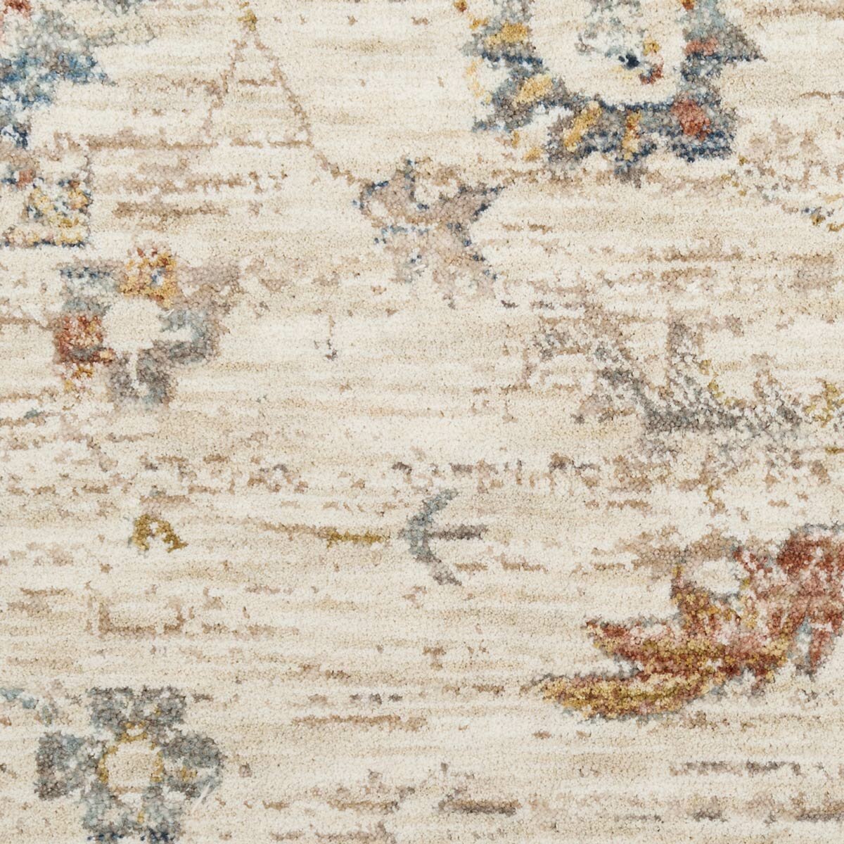 Beige rug with symmetrical floral and geometric pattern in muted blue, red, yellow, and grey