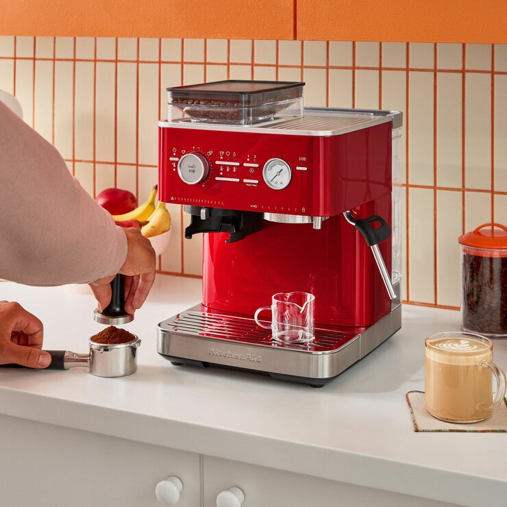 Lifestyle image of KitchenAid Semi Auto Espresso Machine & Burr Grinder showing grinded coffee
