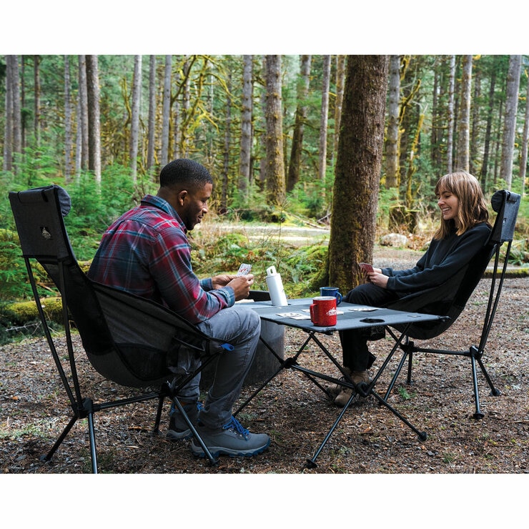 Lifestyle image of two people playing a card game on the table