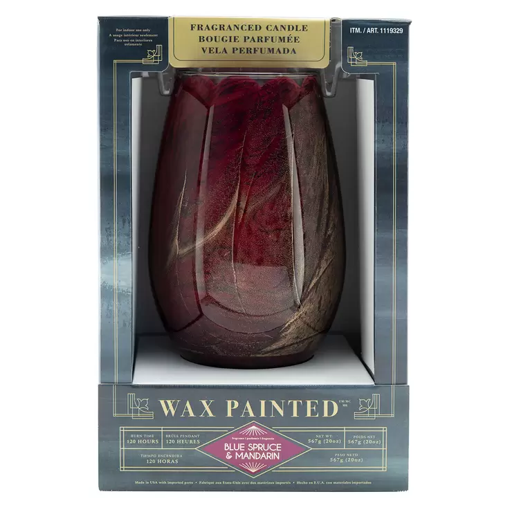 Lifetsyle image of red candle in packaging face on Lifetsyle image of red candle in packaging face on