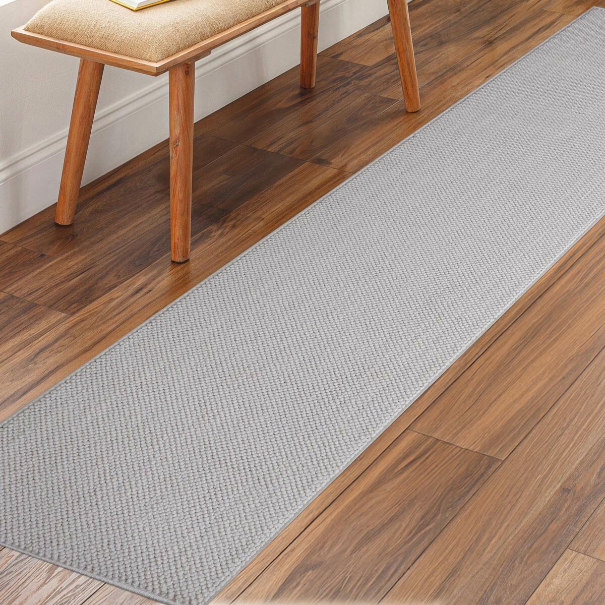 runner rug with a textured surface placed on a wooden floor