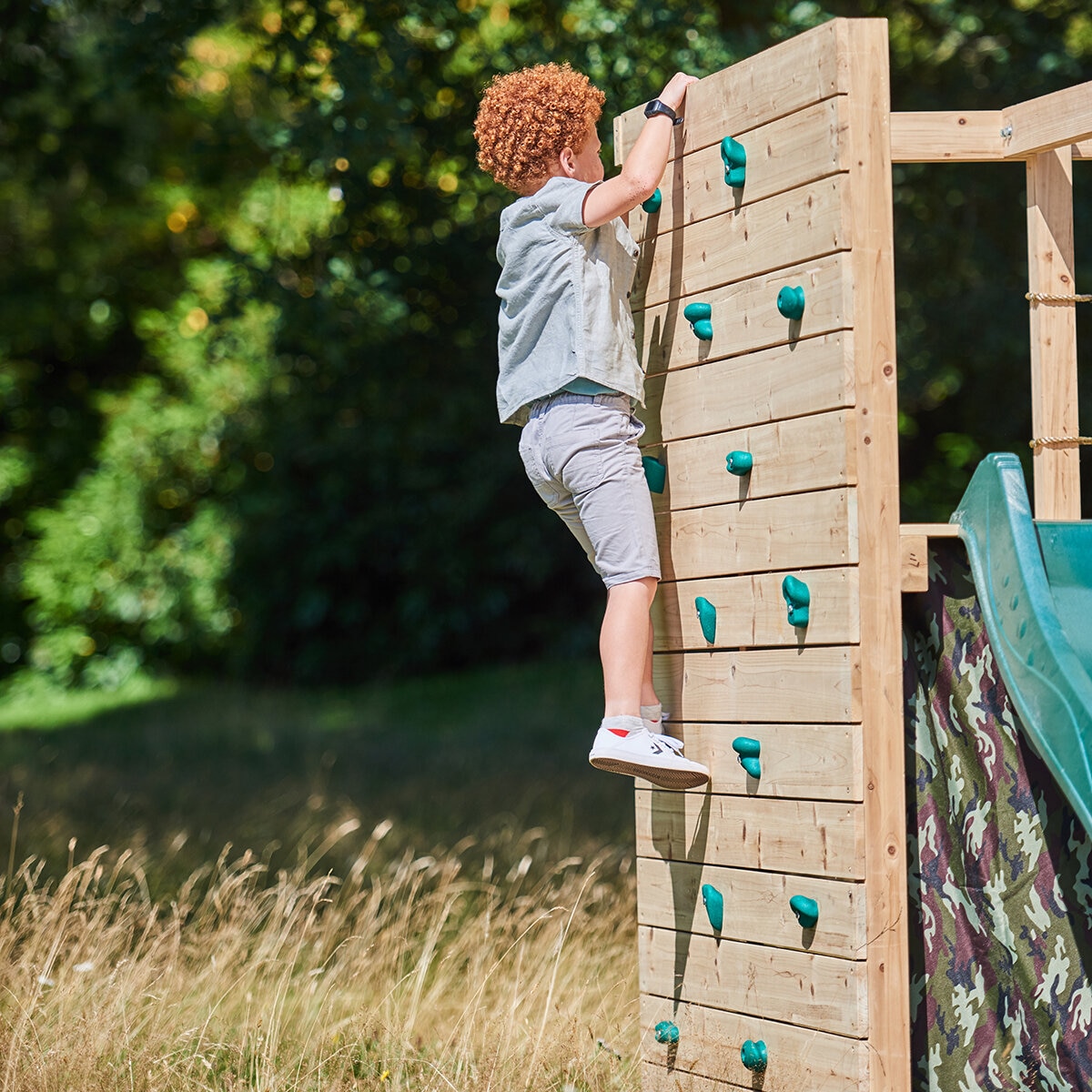 Lifestyle image of a child climbing the rock wall Lifestyle image of a child climbing the rock wall