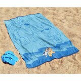 Bluey character beach towel laid out on sand