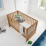 Lifestyle image of cot & mattress in room setting