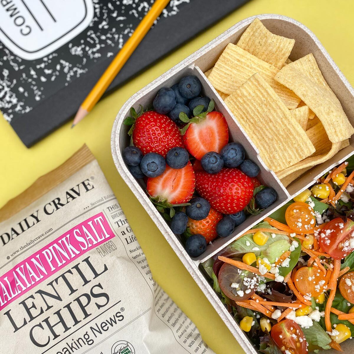 chips in a lunchbox next to fruit