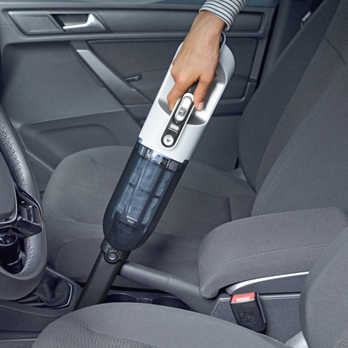 Image of handheld vaccum being used to clean the inside of a car