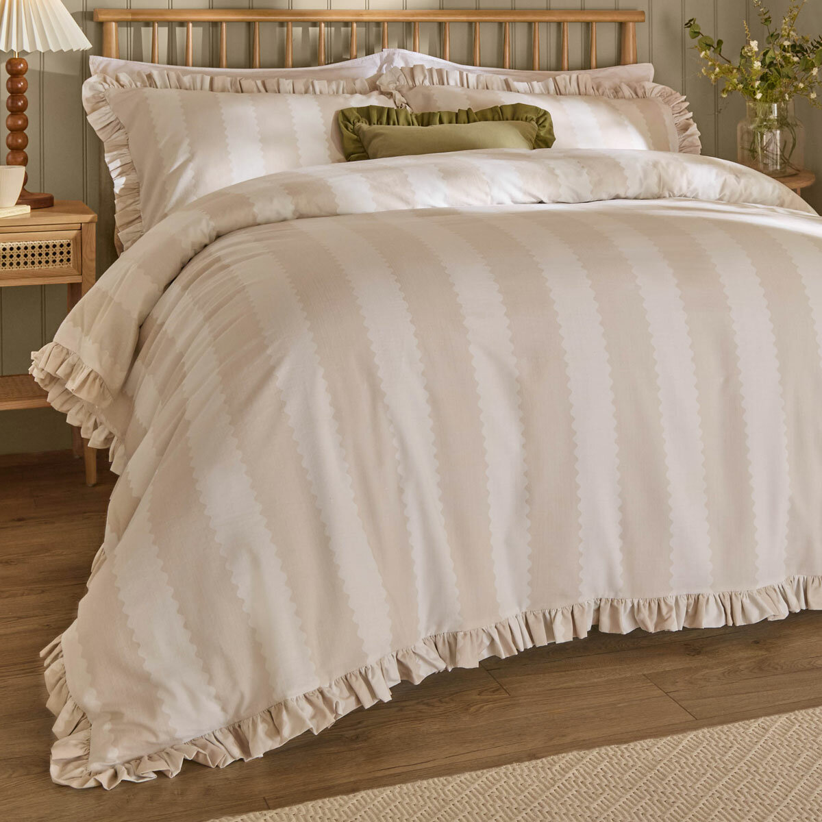 Beige and white striped duvet set with ruffled edges and matching pillow shams.