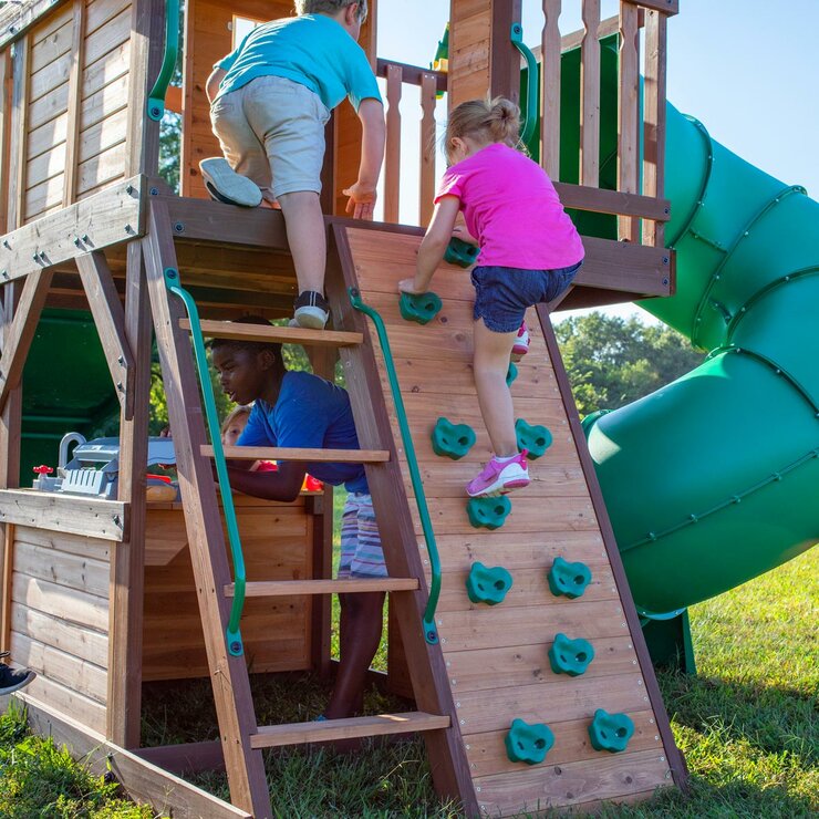 Lifestyle image of children climbing the stairs and rock wall