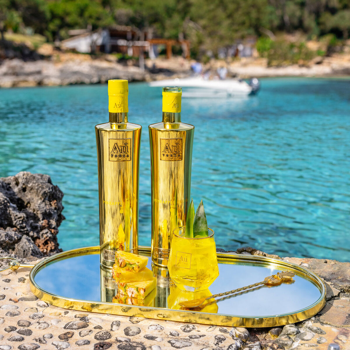 Au Vodka Pineapple Crush bottle on beach