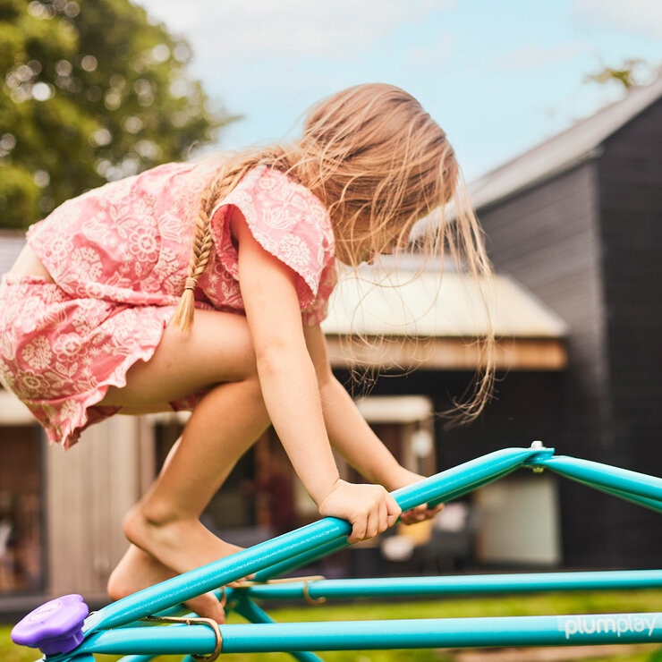 Lifestyle image showing a child climbing the dome