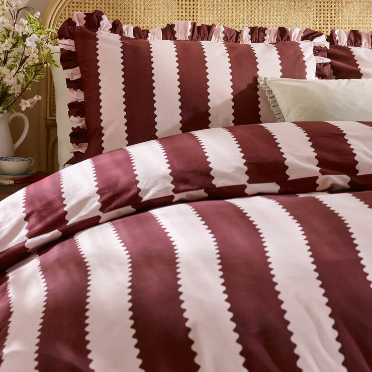 Burgundy and white vertically striped duvet set with ruffled edges and matching pillowcases Burgundy and white vertically striped duvet set with ruffled edges and matching pillowcases