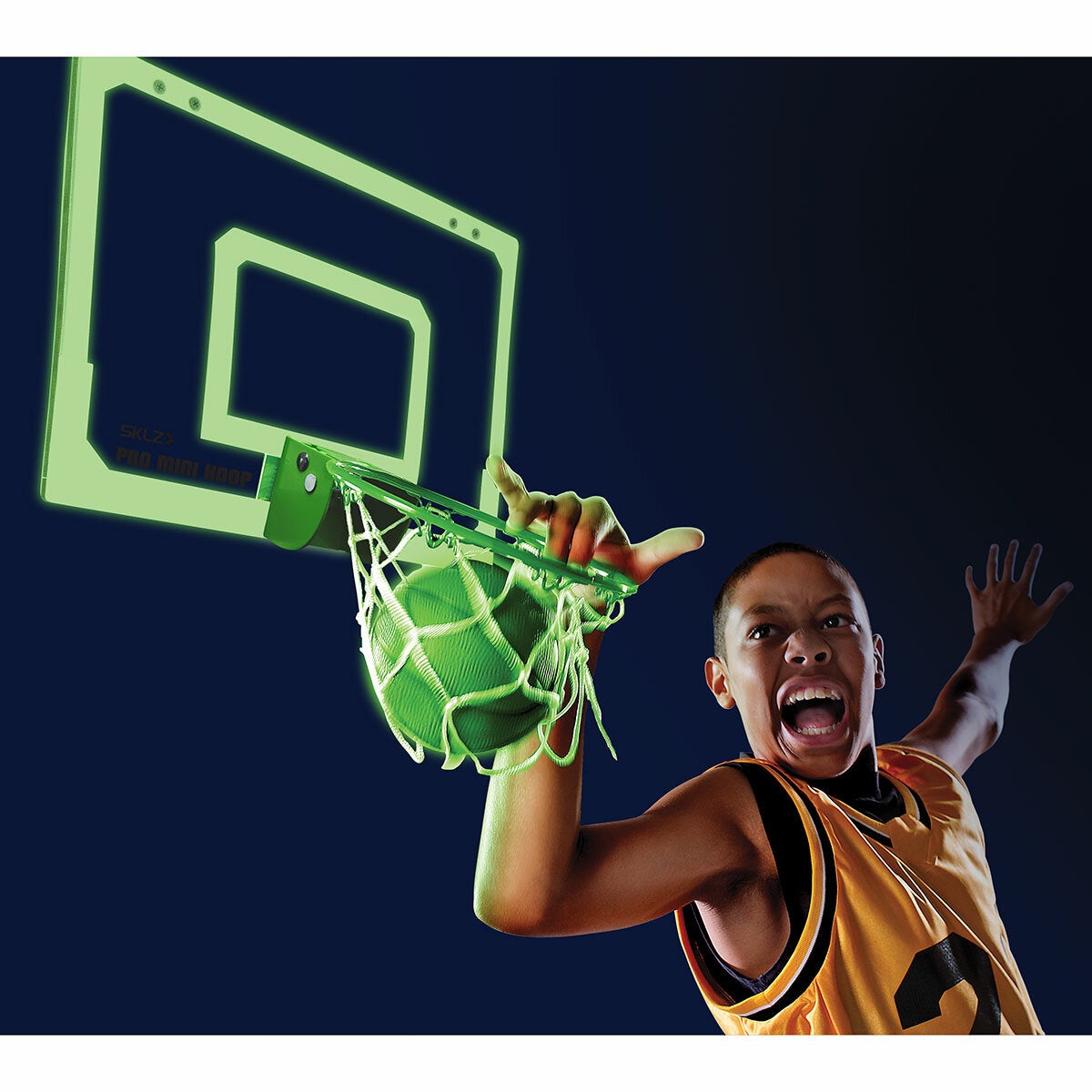 Lifestyle image of a child playing with the SKLZ Pro Mini Hoop Midnight Lifestyle image of a child playing with the SKLZ Pro Mini Hoop Midnight