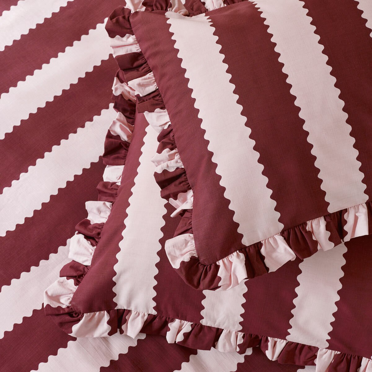 Burgundy and white vertically striped duvet set with ruffled edges and matching pillowcases Burgundy and white vertically striped duvet set with ruffled edges and matching pillowcases