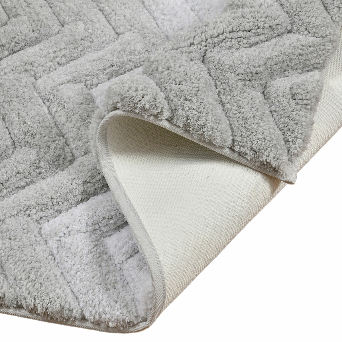 Textured bath mat folded with non skid backing